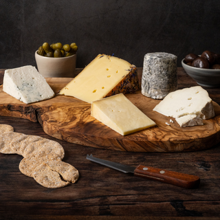 a cheeseboard with four cheeses on it