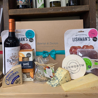 George & Joseph gift box with turquoise ribbon, artisan cheeses, wine, charcuterie, crackers and figs