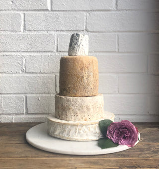 sholebroke cheese wedding cake with dorstone  on the top