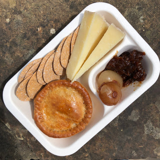 ploughman's chunch - lunch on the go with pork pie, cheddar, chutney crackers and balsamic onions